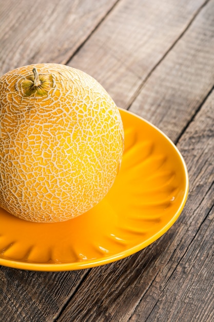 Ripe yellow melon on plate