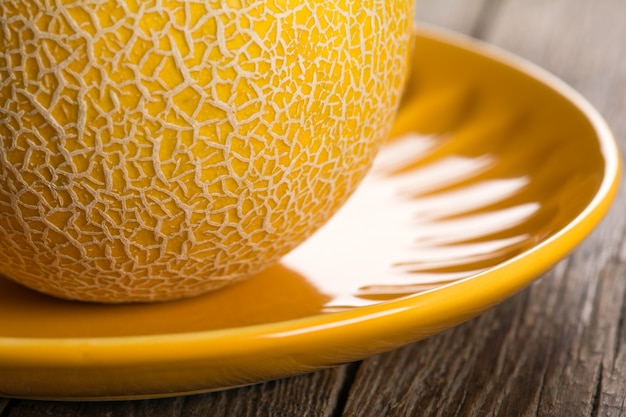 Ripe yellow melon on plate