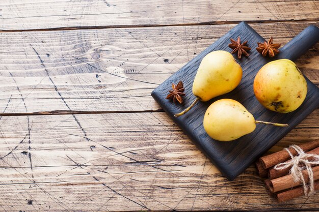 Ripe yellow pears on wooden background