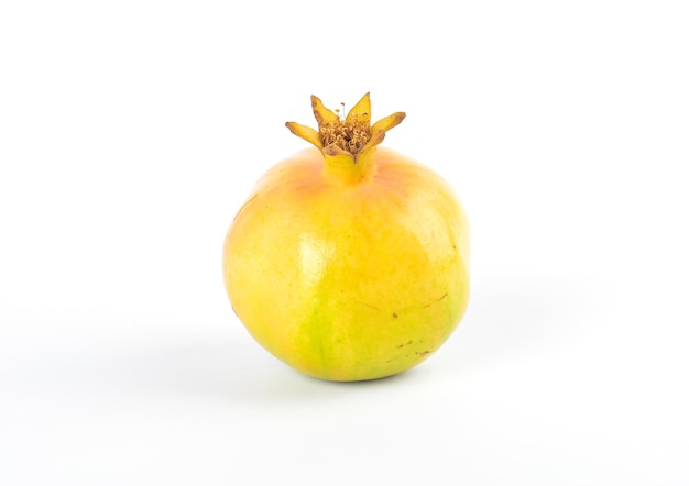 Ripe yellow pomegranates on white background