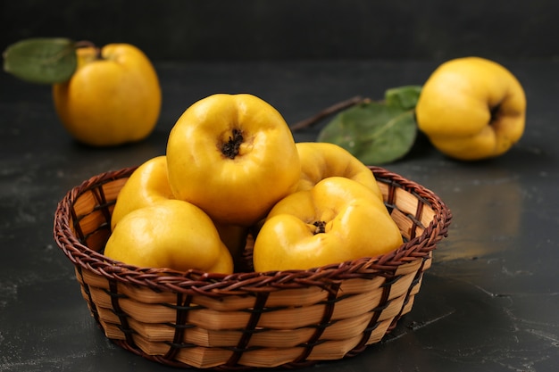 Ripe yellow quince fruit in a wicker basket, healthy lifestyle, horizontal orientation, Closeup