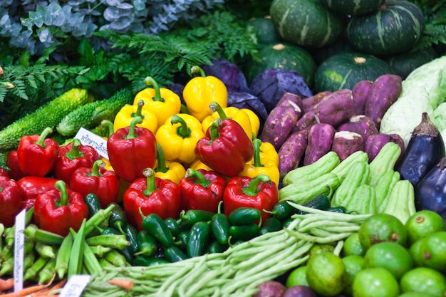 Ripe Yellow, Red and Green Peppers in Vegetables Market