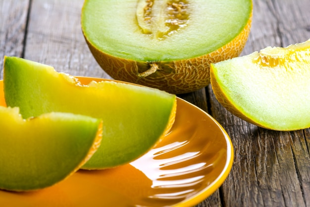 Ripe yellow sliced melon on plate