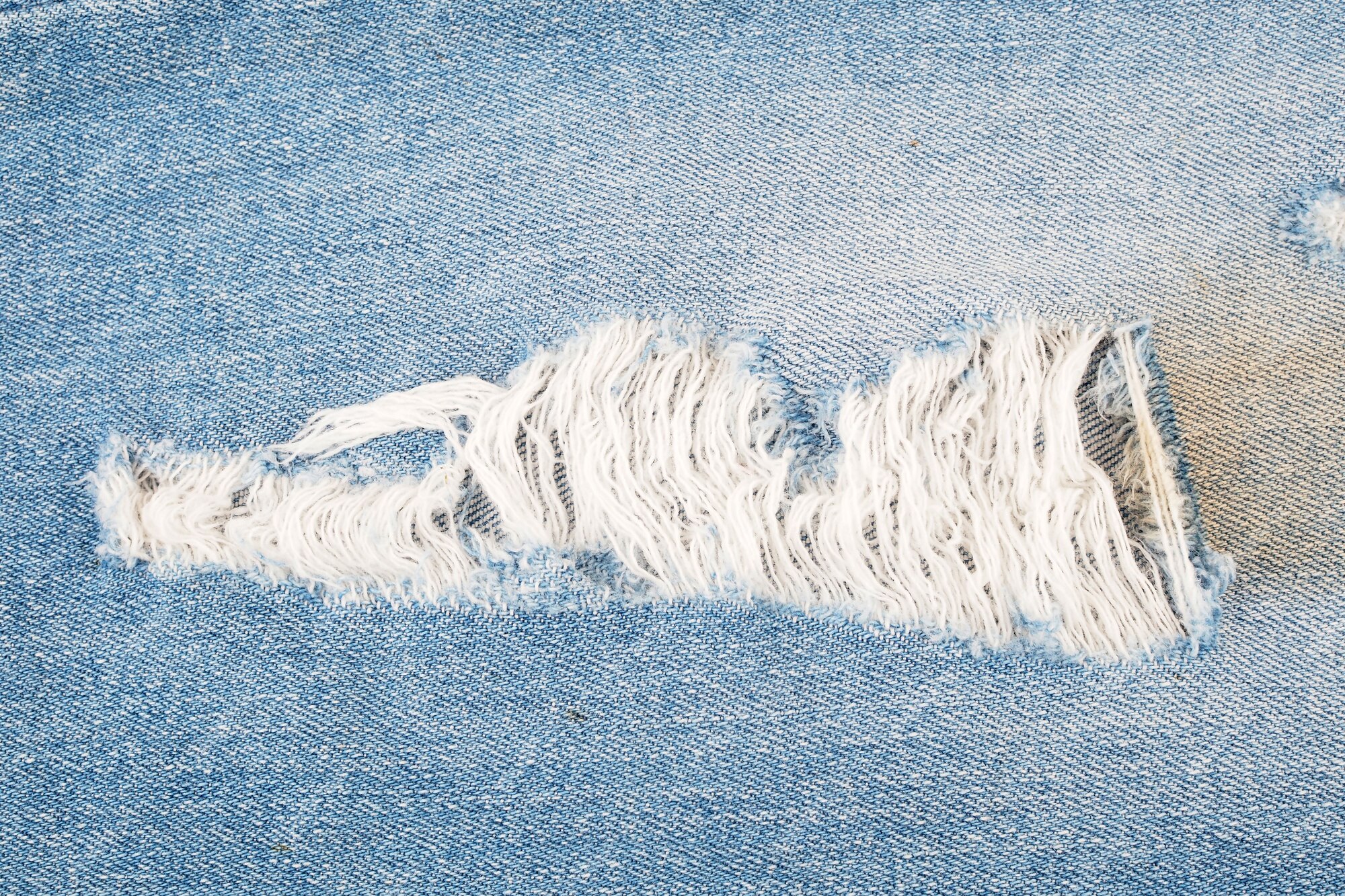 Premium Photo | Ripped blue jeans texture background