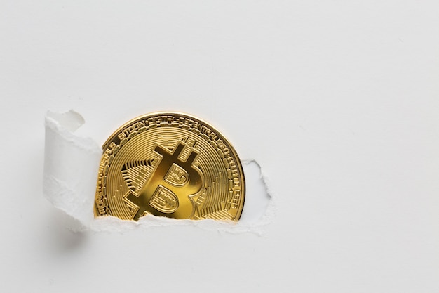 Photo ripped paper revealing bitcoin