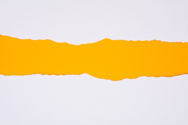 Ripped of white paper on yellow background