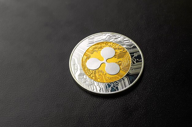 Ripple coin close-up on black background, cryptocurrency business and finance concept, copy space photo