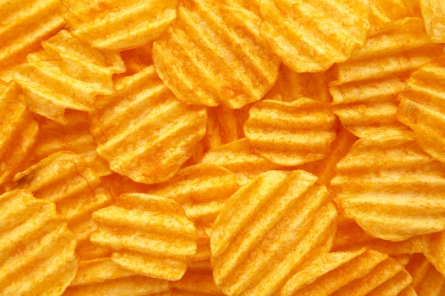 Rippled golden potato chips wall with copy space for text