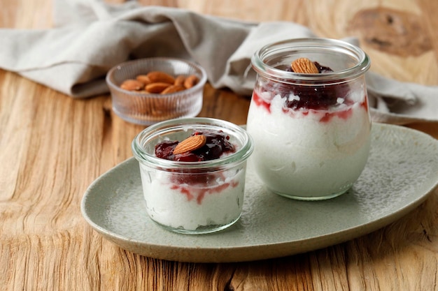 Risalamande, danish dessert rice pudding with vanilla, almonds, and whipped cream, served with warm cherry sauce.