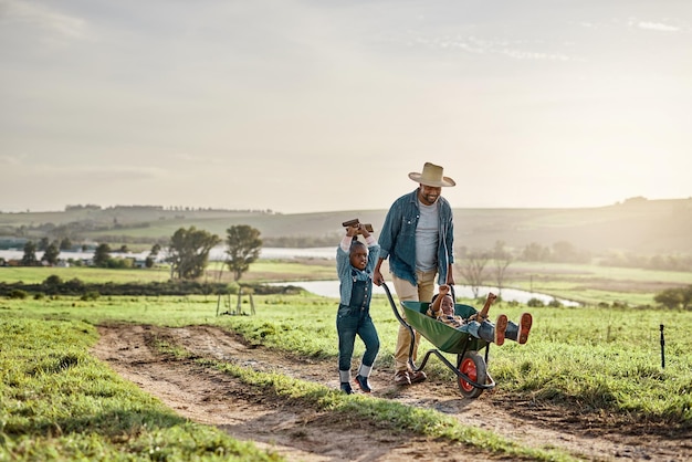 Rise and shine its harvest time Shot of a mature man working his adorable son and daughter on a farm