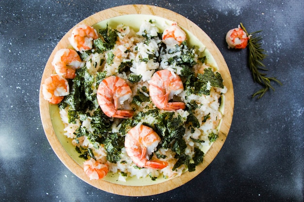 Rise with shrimps and Nori , delishes meal in the plate on the surface, studio shot. Ready to eat.