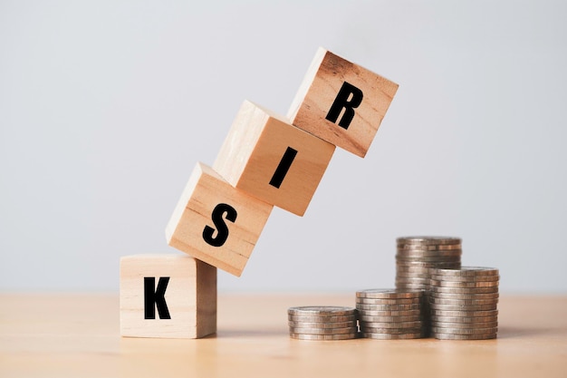 Risico houten blokkubus die valt naar geldmuntstapeling voor financieel risico, beheer en bedrijfsanalyseconcept;