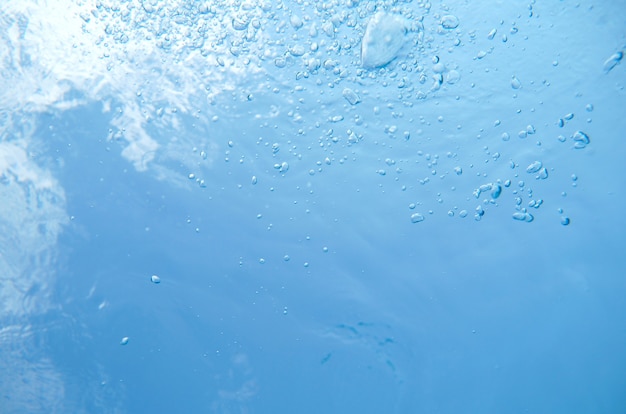 スイミングプールの水中で上昇する泡