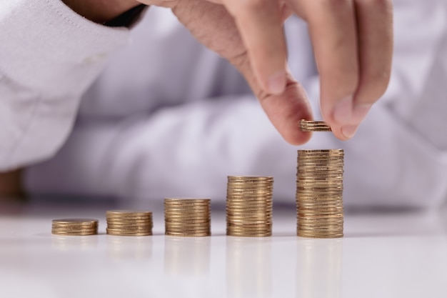 Rising Coins, Stack coin with Businessman hand