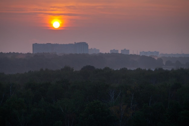 Rising of the sun over city