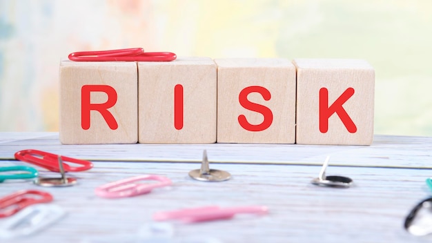 RISK text written on wooden cubes on a light colored background