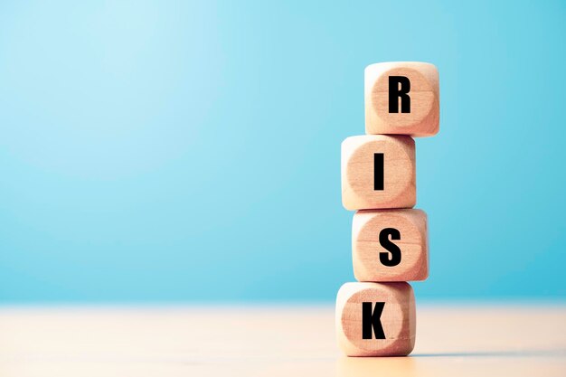 Risk wording print screen on wooden block cube for financial banking risk analysis and management Low risk low return concept