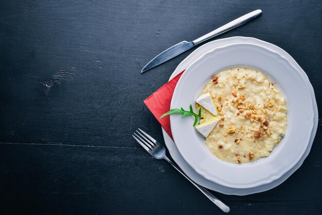 Risotto with cheese on a wooden background Top view Free space for text