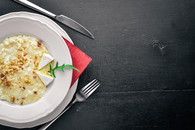 Risotto with cheese on a wooden background Top view Free space for text