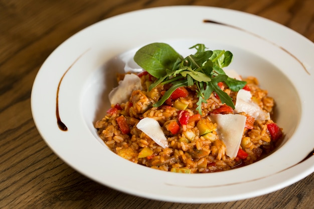 Risotto with chicken meat, zucchini and mushrooms in cream sauce