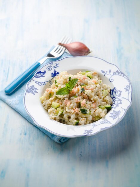 Risotto with fresh salmon and zucchinis selective focus