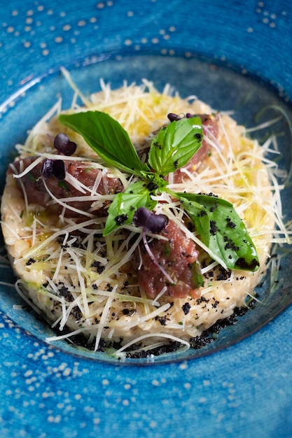 Risotto with Meat on a Blue Plate with Parmesan