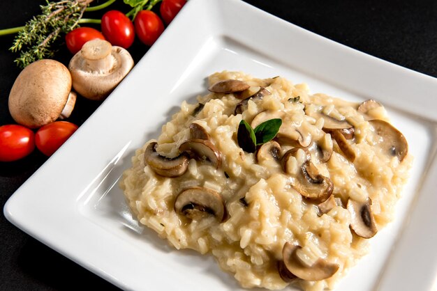 risotto with mushroom on black background