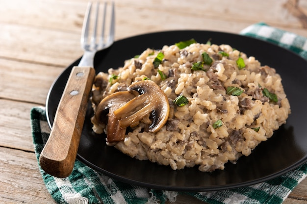 Risotto with mushroom on wooden table