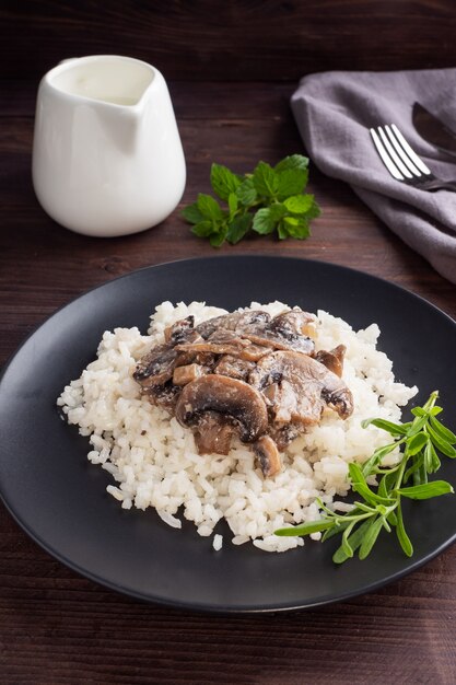 Risotto with mushrooms on a black plate