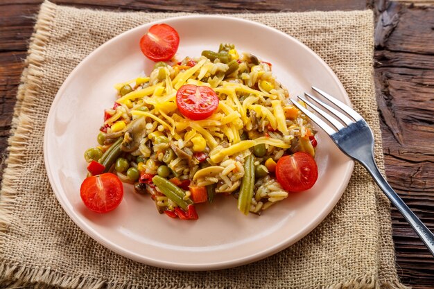 Risotto with mushrooms and cheese in a plate on a linen napkin. Horizontal photo