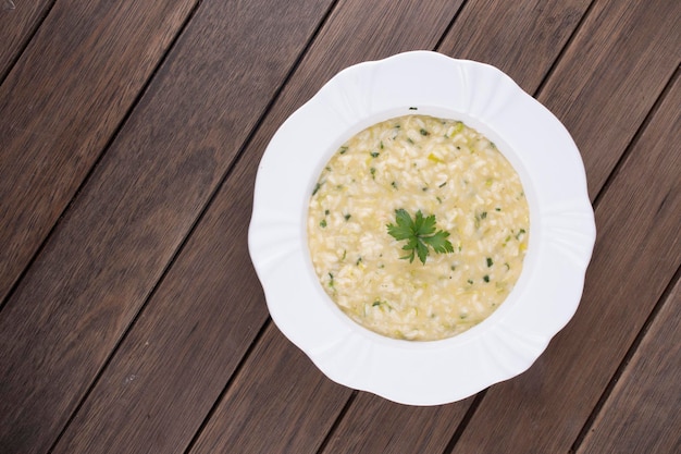 Risotto with parsley viewed from above on rustic wooden table