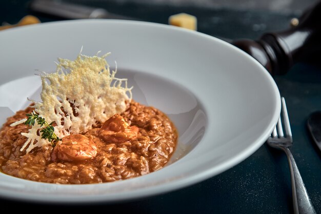 Risotto with pork meat and cheese in white plate