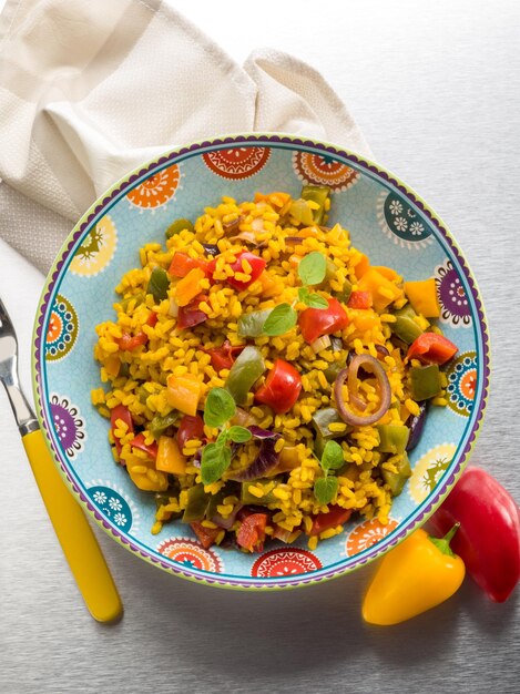 Risotto with saffron and capsicum over steel background