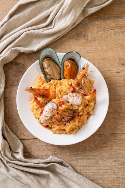 risotto with seafoods (shrimps, mussels, octopus, clams) and tomatoes