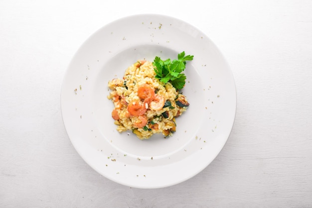 Risotto with shrimp On a wooden background Top view Free space for your text