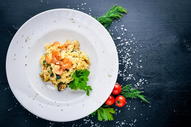 Risotto with shrimp On a wooden background Top view Free space for your text