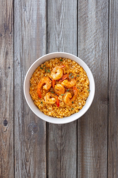 Risotto with shrimps tomatoes and thyme Italian food