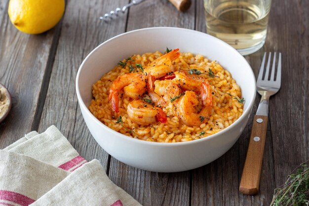 Risotto with shrimps tomatoes and thyme Italian food