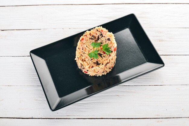 Risotto with vegetables On a wooden background Top view Copy space