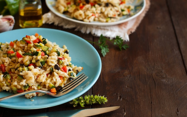 Risotto with vegetables on a wooden table