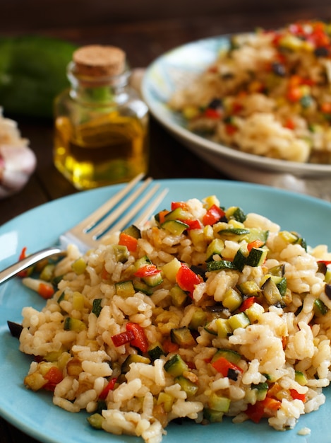 Risotto with vegetables on a wooden table