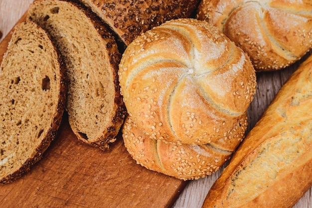 Ãâãâ¡risp bread with buns. french baguettes. fresh crispbread. bread background. different breed on wooden background