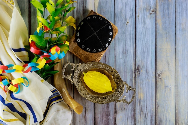 Ritual Jewish festival of Sukkot in the jewish religious symbol Etrog, lulav kippah and tallit