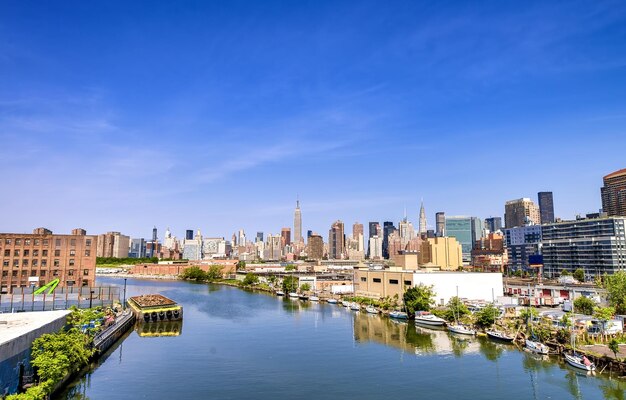 River amidst buildings against blue sky