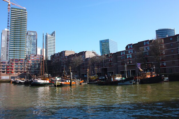 River and buildings against clear blue sky