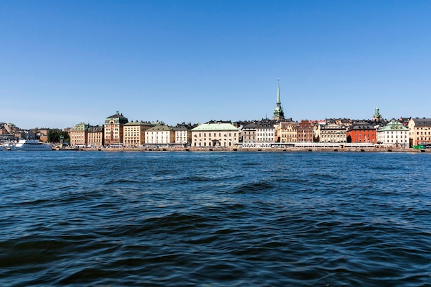 river by buildings against clear blue sky at strandvagen