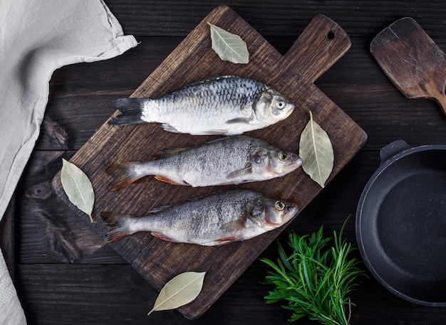 River fish crucian and perch on a brown wooden board