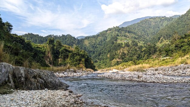 Photo river flowing in village area in nepal