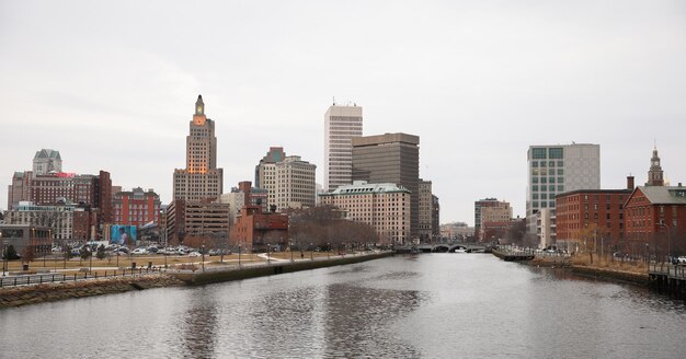 A river flows through a city with the city skyline in the background.