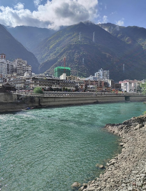 A river runs through a city with a green roof.